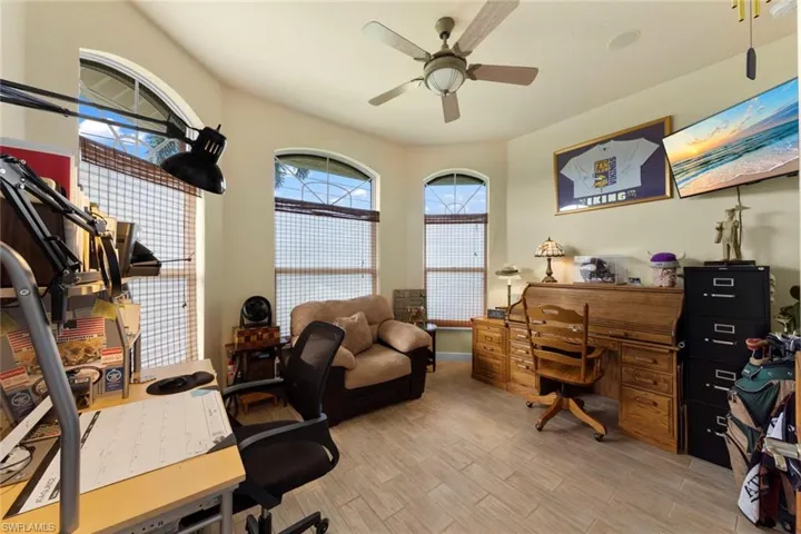 Home office featuring ceiling fan and light hardwood / wood-style flooring