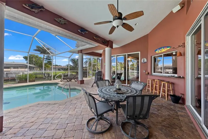 View of pool with ceiling fan