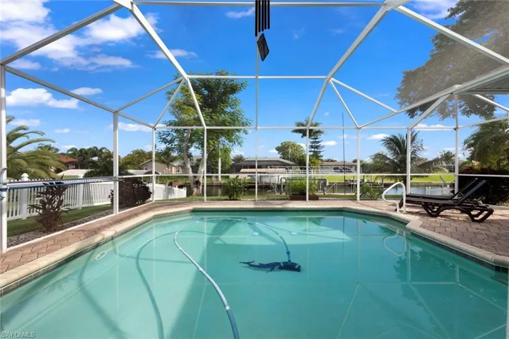 View of swimming pool featuring a patio area and a lanai