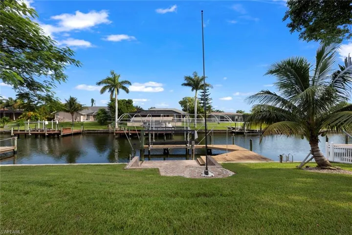 Dock area featuring a lawn and a water view