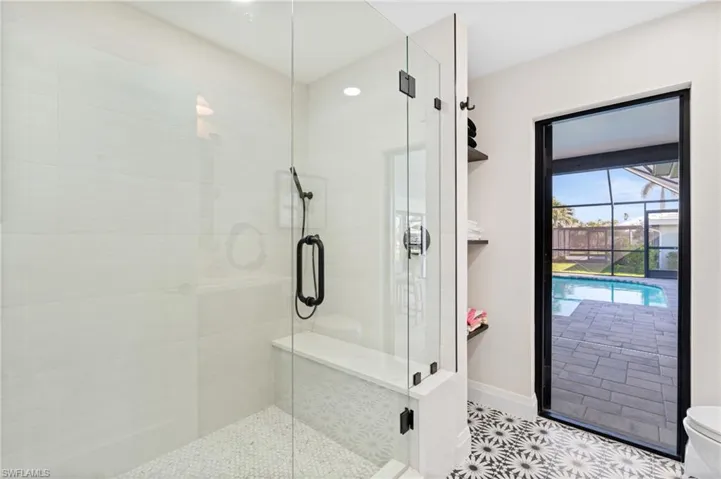 Guest Bathroom and Pool Bath featuring a new walk-in shower.    (Photo digitally enhanced)