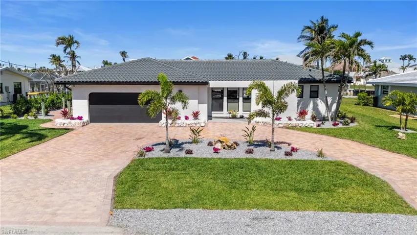 Fresh landscaping, tile roof and fresh paint make this Home Sweet Home! (Photo digitally enhanced)