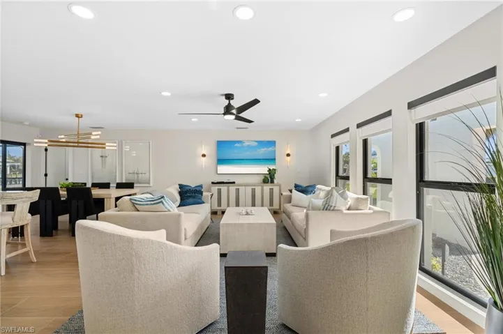 Living room area filled with designer furniture and plenty of sunshine.    (Photo digitally enhanced)