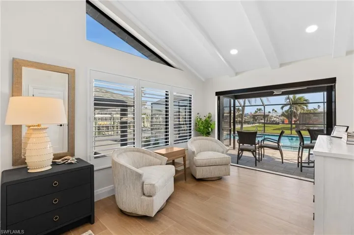 Sitting area in spacious guest Bedroom with cathedral ceiling opening out to the pool. (Photo digitally enhanced)