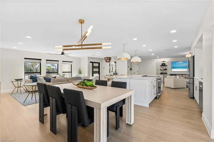 Wow!  So open and inviting!  Hugh kitchen island, open family room with plenty of sunshine  and then the cozy sitting area to the right.   (Photo digitally enhanced)