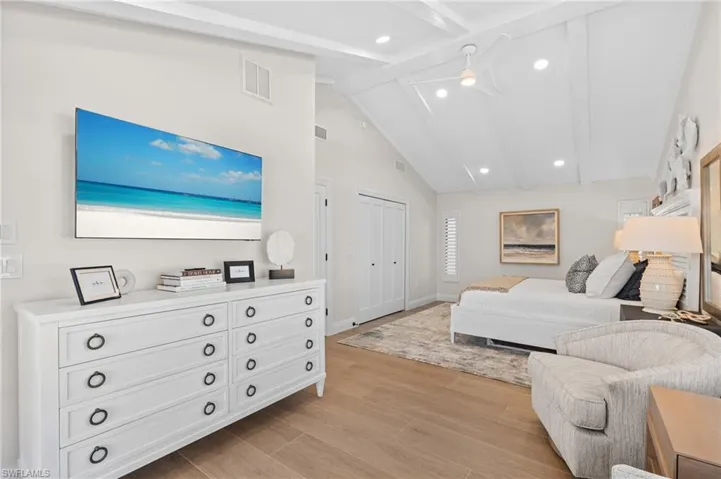 Very large guest bedroom with sitting area and featuring a cathedral ceiling.    (Photo digitally enhanced)