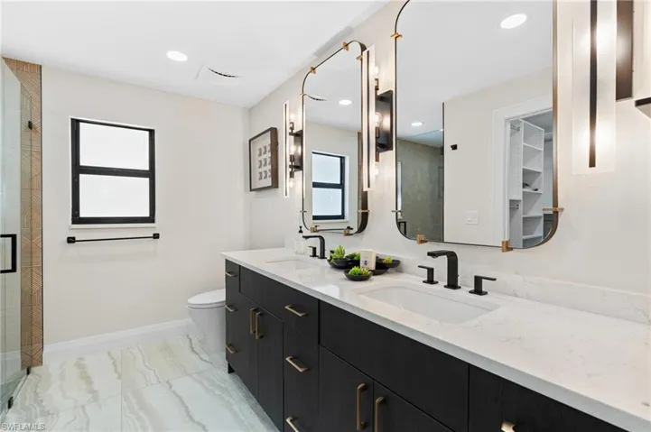 Primary Bedroom Ensuite bathroom featuring dual sinks and walk-in shower.    (Photo digitally enhanced)