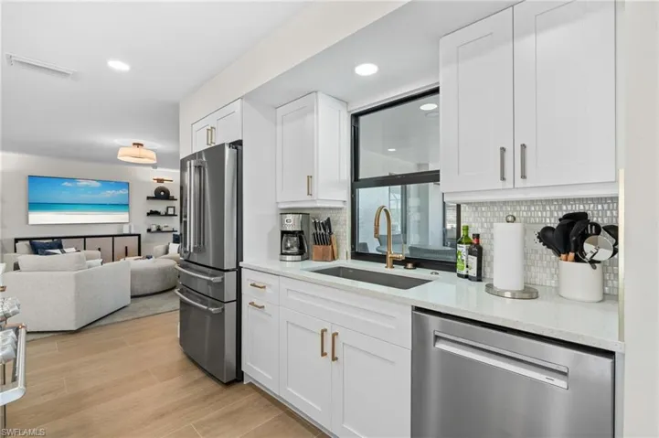 New kitchen includes beautiful backsplash, new stainless steel appliances.      (Photo digitally enhanced)