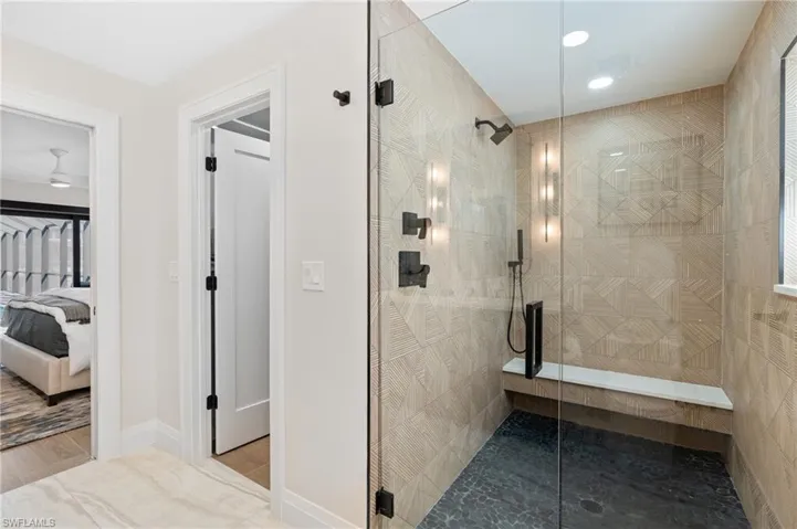 Primary ensuite bathroom featuring beautifully renovated walk-in shower.    (Photo digitally enhanced)