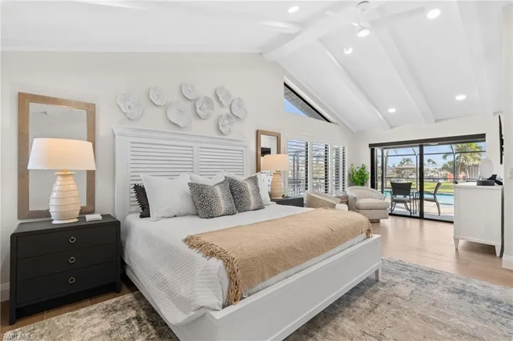 Bedroom featuring cathedral ceiling, large enough for a sitting area over the pool.  (Photo digitally enhanced)