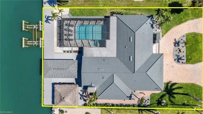 This home has it all!  Pavered Circular driveway, Refreshed pool/hot tub, Tiki hut shaded area and hugh boat dock and lift!  (Photo digitally enhanced)