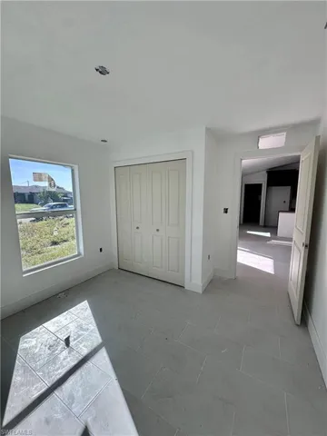 Unfurnished bedroom with baseboards and a closet