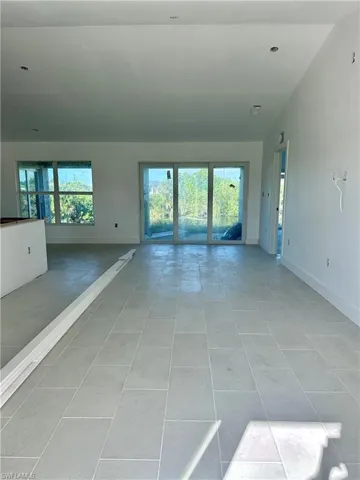 Unfurnished living room with light tile patterned floors