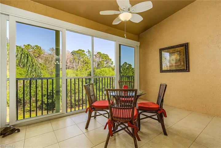 Sunroom with ceiling fan and vaulted ceiling