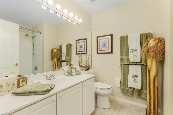 Bathroom with tile patterned floors, vanity, and toilet