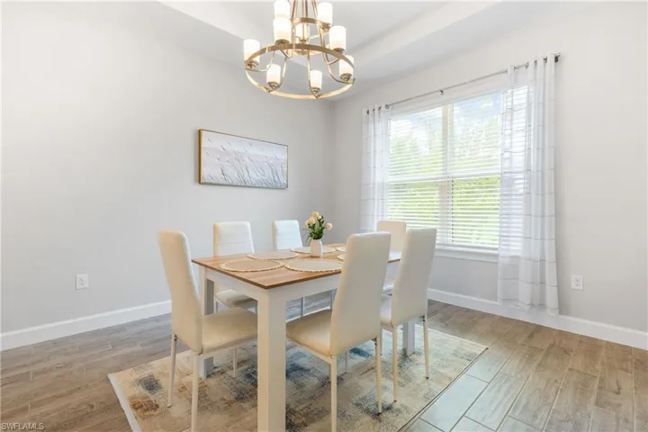 Dining space featuring light wood-style floors and a chandelier