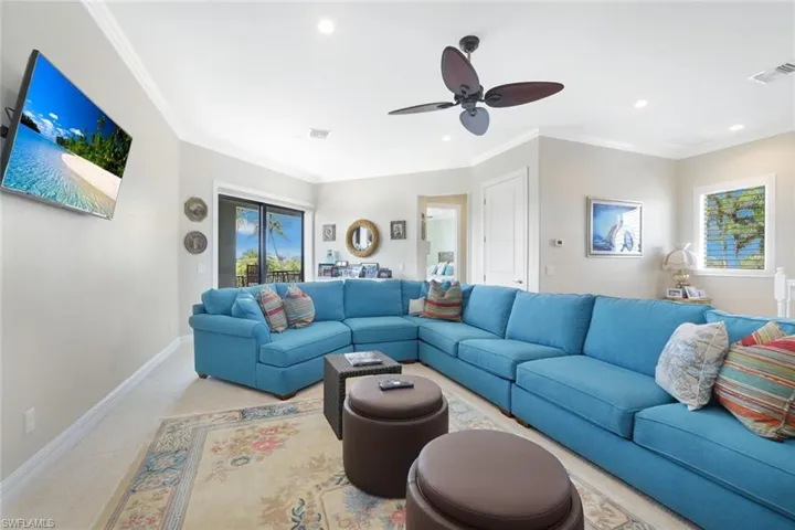 Upstairs Living room featuring crown molding, carpet, and ceiling fan