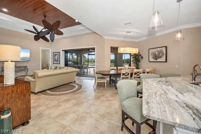 Living room featuring ceiling fan, sink, wooden ceiling, and ornamental molding