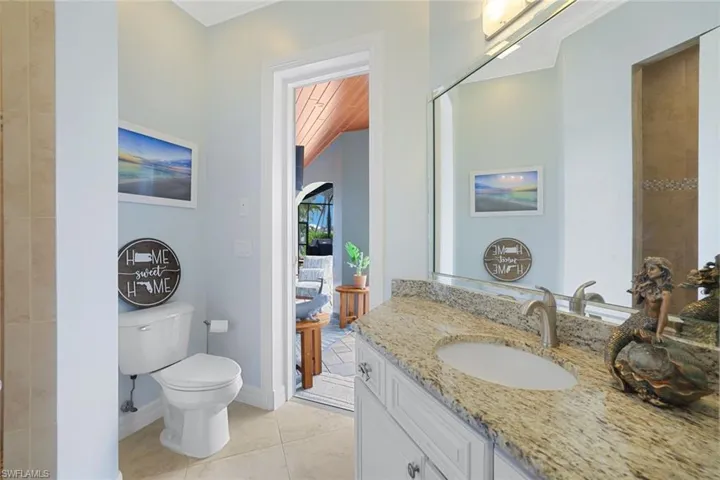 2nd Guest Bathroom featuring vanity with extensive cabinet space, tile flooring, and toilet