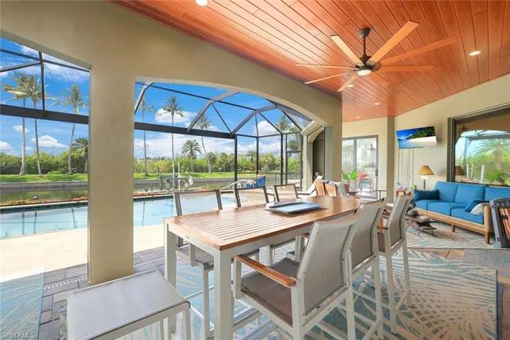 Sunroom / solarium featuring wooden ceiling, a healthy amount of sunlight, and ceiling fan