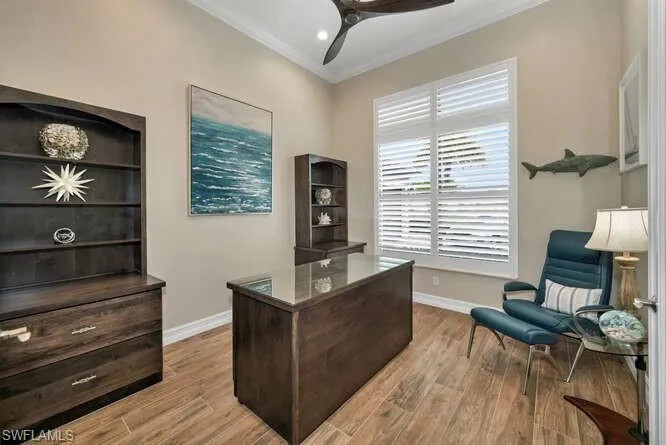 Office space/Study with light wood-type flooring, ceiling fan, and ornamental molding
