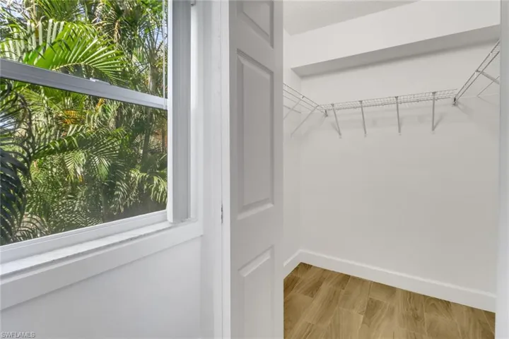 Walk in closet featuring light wood-style flooring