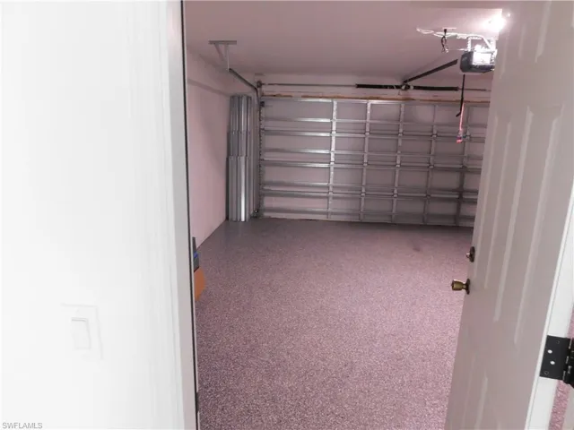 Garage featuring a garage door opener