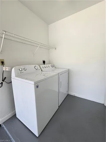 Laundry room with washer and clothes dryer