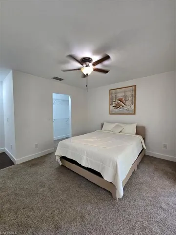 Carpeted bedroom with ceiling fan