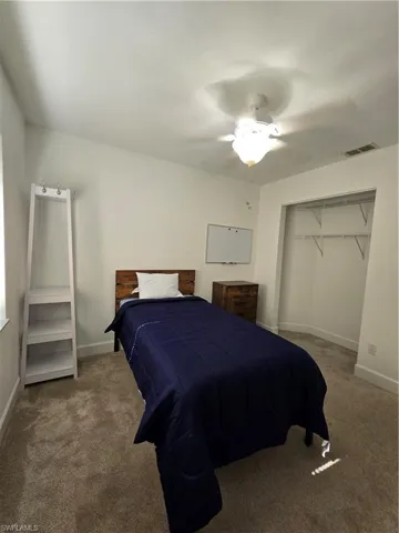 Bedroom featuring carpet, a closet, and ceiling fan