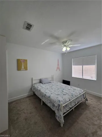 Bedroom featuring carpet floors and ceiling fan
