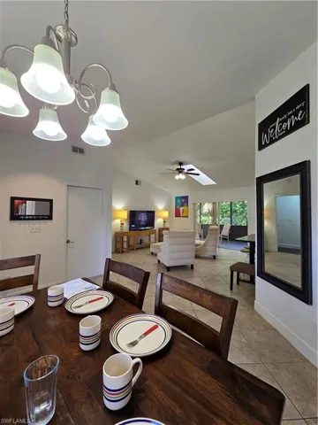Dining space featuring ceiling fan and lofted ceiling