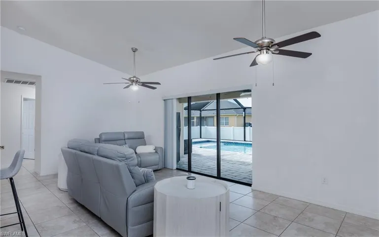 Interior space featuring tiled flooring and a pair of ceiling fans