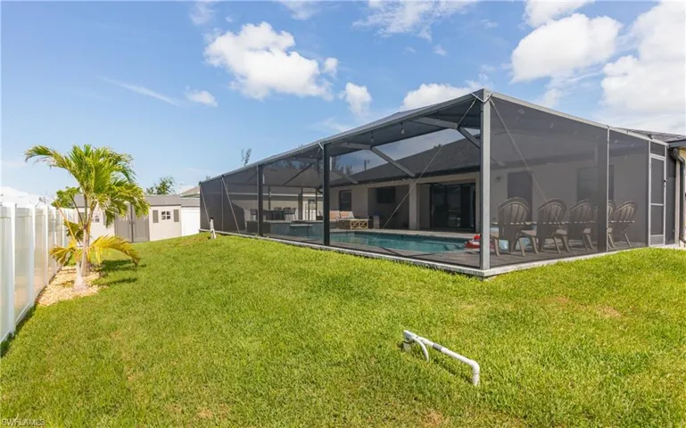 Screened-in patio with an in-ground swimming pool and ample decking