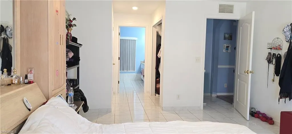 Bedroom featuring a closet and light tile patterned floors