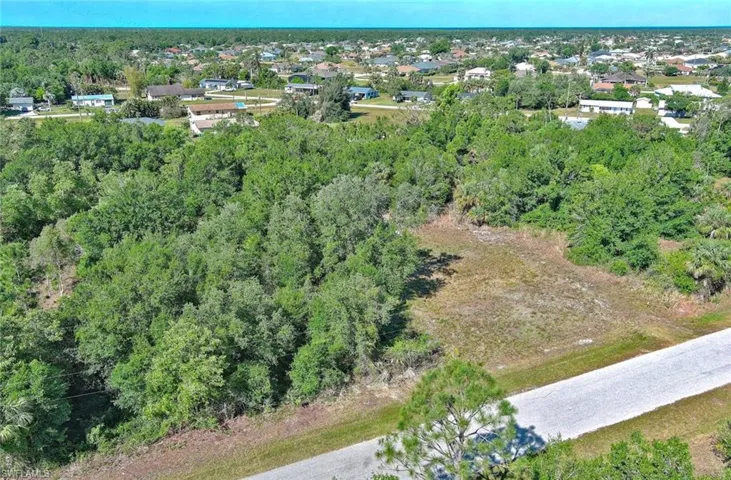 Aerial view of property's location with a forest