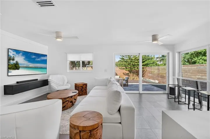 Living room featuring ceiling fan and light tile patterned floors