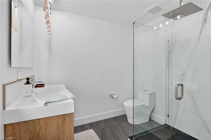 Full bathroom with vanity and a marble finish shower