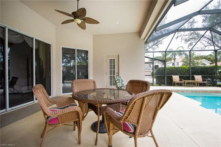 View of patio with a lanai and ceiling fan