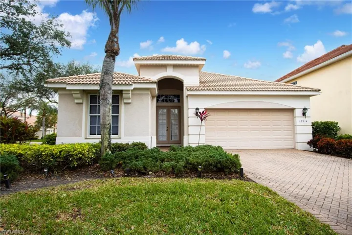 Mediterranean / spanish house with a garage and french doors