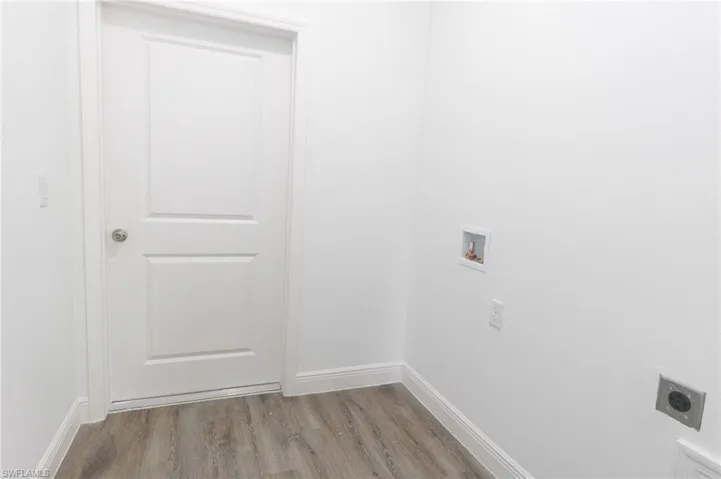 Laundry room featuring hookup for an electric dryer, laundry area, washer hookup, and light vinyl floors