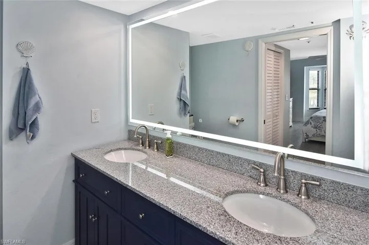 Bathroom is well-lit using a back-lit mirror.
