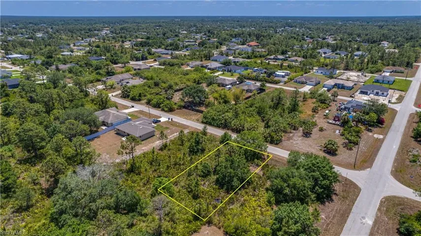 Aerial view of residential area featuring property boundaries highlighted