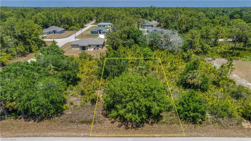View of property location featuring property parcel outlined and a forest