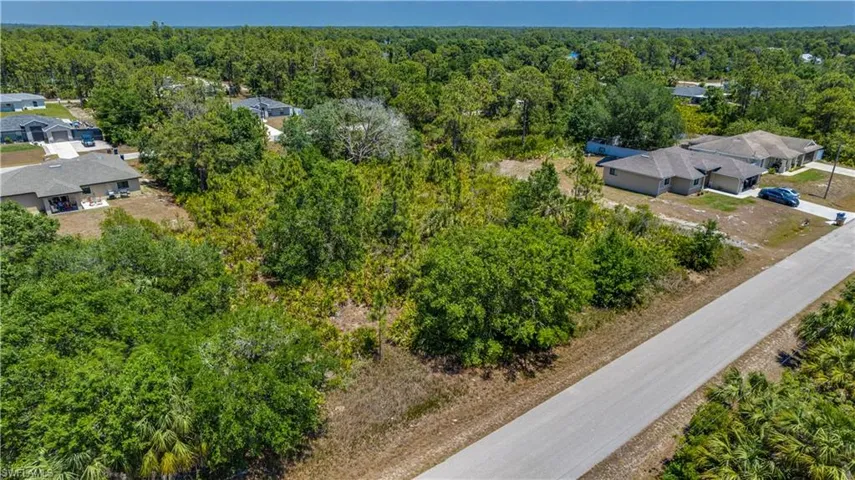 View from above of property with a forest