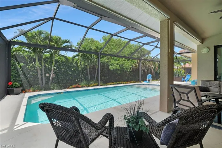 Outdoor pool featuring a patio and glass enclosure