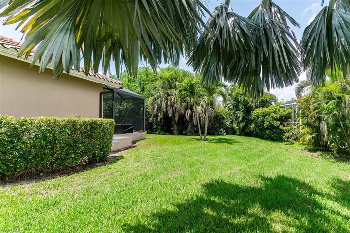 View of grassy yard with a lanai