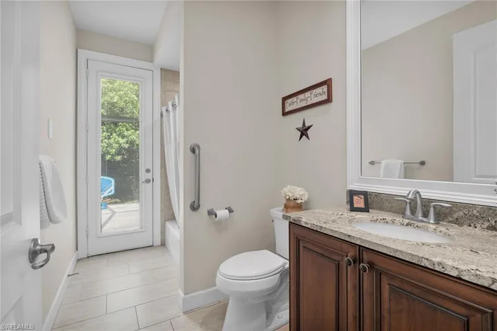 Full bath featuring vanity, baseboards, toilet, and shower / tub combo
