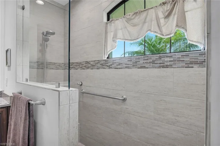 Full bath with a walk in shower, plenty of natural light, and vanity