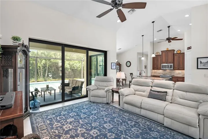 Living area featuring a ceiling fan, recessed lighting, and high vaulted ceiling